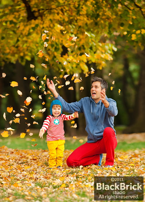 Photo of father and son having fun on a autumn day