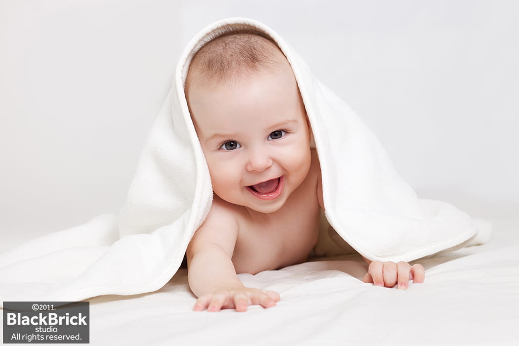 Portrait of a beautiful baby under a blanket