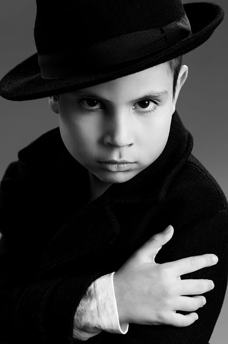 Black and white studio portrait of a boy